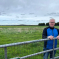 Phil Loughlin standing behind a gate overlooking the fields next to Station Road in The Humbers