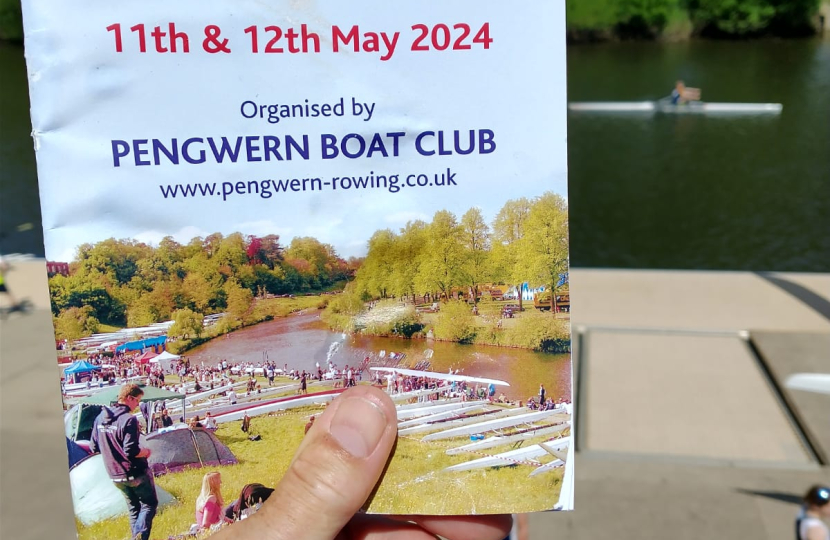 A flyer for the Regatta being held in a hand.